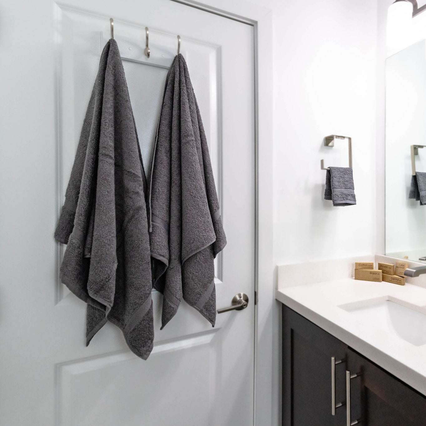 Stylishly arranged Oxford Imperiale Large Grey Bath Towels add luxury to any bathroom, perfect for hotels or Airbnb.