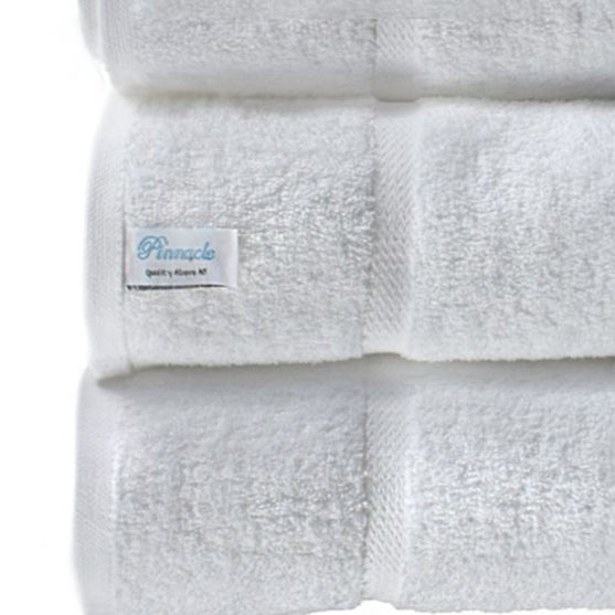 Luxurious Pinnacle Bath towels in brilliant white, crafted from 100% combed cotton for softness and durability.