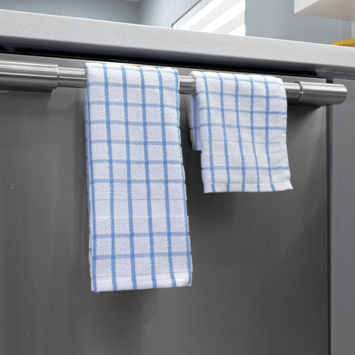 Stylish Premium Kitchen Towels – 12-Pack hanging on a bar, perfect for everyday cleaning and drying tasks.