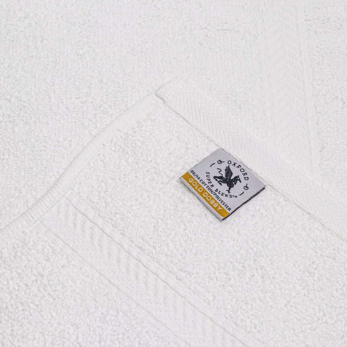 Luxurious Oxford Gold Dobby Towels in brilliant white, combining softness and durability for lasting performance.