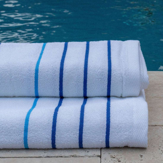Soft and absorbent Pinnacle Premium Pool Towels 35" x 70" with vibrant stripes, ideal for luxury poolside settings.