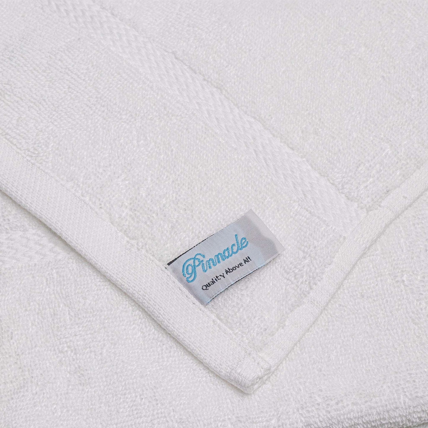 Luxurious Pinnacle Bath towels in brilliant white, crafted from 100% combed cotton for softness and durability.
