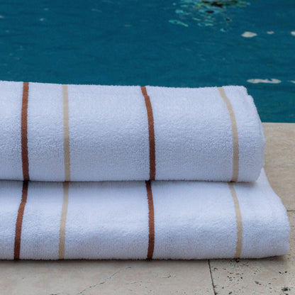 Soft and absorbent Pinnacle Premium Pool Towels 35" x 70" with bright stripes, perfect for luxury poolside settings.