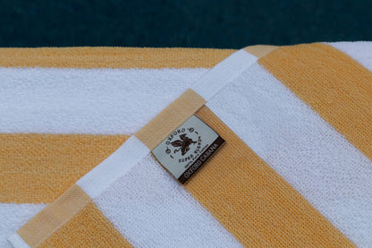 Oxford Premium Cabana Stripe Towels 30"x70" in vibrant yellow and white, perfect for poolside relaxation.